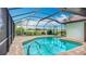 Enjoy a sparkling screened-in pool, perfect for relaxation, with lush landscaping and a golf course view at 8822 Misty Creek Dr, Sarasota, FL 34241