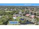 An aerial view of the community showing the pool, tennis courts, ponds, and lush landscaping surrounding the homes at 9521 86Th Ave # 9521, Seminole, FL 33777