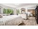 Bedroom with a large bed, mirror, and outdoor view at 9521 86Th Ave # 9521, Seminole, FL 33777