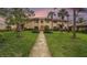 Charming two-story townhome showcasing landscaped front yard, manicured hedges, and a tile roof at 9521 86Th Ave # 9521, Seminole, FL 33777