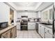 Well-lit kitchen with white cabinetry, modern appliances, and tiled floor at 9521 86Th Ave # 9521, Seminole, FL 33777