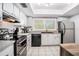 The kitchen has white cabinets, sleek countertops and stainless steel appliances at 9521 86Th Ave # 9521, Seminole, FL 33777