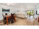 Light-filled living room with wood floors, neutral sofa, and sliding doors to a screened patio at 9521 86Th Ave # 9521, Seminole, FL 33777