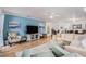 Inviting living room with wood floors, neutral sectional, and seamlessly connecting with adjacent rooms at 9521 86Th Ave # 9521, Seminole, FL 33777