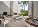 A charming courtyard with a picnic table and seating surrounded by mature palm trees at 960 Virginia St # 202, Dunedin, FL 34698
