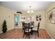 Bright dining area with elegant chandelier and direct access to bedroom and living room at 960 Virginia St # 202, Dunedin, FL 34698