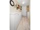 Entryway with tiled floor has ample storage with white cabinets and decorative wall accents at 960 Virginia St # 202, Dunedin, FL 34698