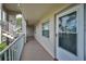 Hallway showcases the unit's entrance with a secure door, adjacent to well-lit stairs at 960 Virginia St # 202, Dunedin, FL 34698