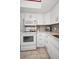 Well-lit kitchen with white cabinets, modern appliances, and stylish tile backsplash at 960 Virginia St # 202, Dunedin, FL 34698