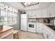 Bright kitchen featuring white cabinets, modern appliances, and a window with natural light at 960 Virginia St # 202, Dunedin, FL 34698