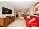 Open-concept living room with comfortable seating, ceiling fan, and ample natural light at 960 Virginia St # 202, Dunedin, FL 34698