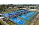 Aerial view of numerous outdoor pickleball courts, promising an active lifestyle in a vibrant community at 960 Virginia St # 202, Dunedin, FL 34698