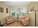 A sun room with hardwood floors offers a serene view of the lake and lots of sunlight at 960 Virginia St # 202, Dunedin, FL 34698