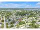 Aerial view showing location; single-Gathering homes, landscaping, nearby lake and roads at 9892 111Th St, Seminole, FL 33772