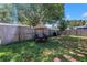 Fenced backyard with green grass, shady tree, patio furniture and black grill, a private outdoor space at 9892 111Th St, Seminole, FL 33772