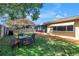 Backyard with a seating area and an umbrella table, ideal for outdoor entertaining and relaxation at 9892 111Th St, Seminole, FL 33772