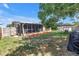 Landscaped backyard with patio area, screened lanai, and a lush green lawn, ideal for outdoor gatherings at 9892 111Th St, Seminole, FL 33772