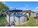 Backyard pool with surrounding landscaping and seating offers a private and relaxing outdoor space at 9892 111Th St, Seminole, FL 33772