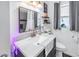 Bright bathroom featuring a granite vanity top, recessed mirror, decorative accents, and neutral color palette at 9892 111Th St, Seminole, FL 33772