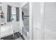 Bright bathroom featuring white tiled shower and linen closet at 9892 111Th St, Seminole, FL 33772