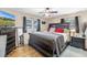 Main bedroom featuring a ceiling fan, hard wood floors, and natural light at 9892 111Th St, Seminole, FL 33772