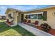 Charming home featuring well-manicured landscaping and a cozy seating area on the front porch at 9892 111Th St, Seminole, FL 33772