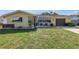 Inviting single-story home with a well-maintained lawn, tidy flower beds, and a cozy seating area at 9892 111Th St, Seminole, FL 33772