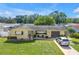 A well-maintained single Gathering home with a manicured lawn, flowerbeds, and a cozy seating area at 9892 111Th St, Seminole, FL 33772