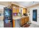 Cozy kitchen featuring stainless steel dishwasher, double sinks, and oak cabinets at 9892 111Th St, Seminole, FL 33772