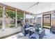 Covered lanai featuring comfortable seating and views of the fenced backyard, perfect for outdoor relaxation at 9892 111Th St, Seminole, FL 33772