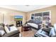 Inviting living room offers tile flooring, comfortable seating and natural light from large window at 9892 111Th St, Seminole, FL 33772