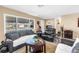 A cozy living room featuring tile flooring, a large window and comfortable dark sofas at 9892 111Th St, Seminole, FL 33772