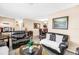 The living room has tile floors and comfortable seating with view into the dining area at 9892 111Th St, Seminole, FL 33772