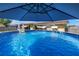 Backyard features a refreshing above-ground pool with a fountain and umbrella, perfect for summer relaxation at 9892 111Th St, Seminole, FL 33772