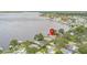 A high aerial shot showcases a lakefront property with docks and a serene, watery backdrop at 115 Lake Shore E Dr, Palm Harbor, FL 34684