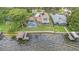 Aerial view of backyard with pool, dock and waterfront at 115 Lake Shore E Dr, Palm Harbor, FL 34684