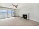 Bright living room with a fireplace and sliding glass doors offering beautiful lake views at 115 Lake Shore E Dr, Palm Harbor, FL 34684