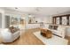 Bright living room with sliding doors leading to the pool area, offering seamless indoor-outdoor living at 115 Lake Shore E Dr, Palm Harbor, FL 34684