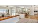 Open-concept living area with views of the lake, dining area, and kitchen, creating a welcoming space at 115 Lake Shore E Dr, Palm Harbor, FL 34684