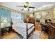 Bedroom with a ceiling fan, desk, and a comfortable bed at 1151 Lancer Ln, Tarpon Springs, FL 34689