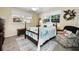 Bedroom with a four-poster bed, an area rug, natural light, and a comfortable chair at 1151 Lancer Ln, Tarpon Springs, FL 34689