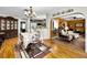 View of dining room and open floor plan with hardwood floors, ornate chandelier, and access to the living room and kitchen at 1151 Lancer Ln, Tarpon Springs, FL 34689