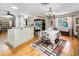 View of dining room featuring hardwood floors, chandelier, white kitchen cabinetry, and a large window at 1151 Lancer Ln, Tarpon Springs, FL 34689