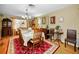Traditional dining room with hardwood floors and a decorative red rug under the table at 1151 Lancer Ln, Tarpon Springs, FL 34689
