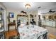 Open-concept dining area with views of the kitchen and outdoor patio at 1151 Lancer Ln, Tarpon Springs, FL 34689