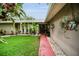 Welcoming home exterior with manicured lawn and colorful hanging plants at 1151 Lancer Ln, Tarpon Springs, FL 34689