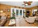 Cozy living room with tile flooring, ceiling fan, and view of the outdoor pool at 1151 Lancer Ln, Tarpon Springs, FL 34689