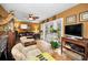 Cozy living room with comfortable seating, tiled floors and access to a patio at 1151 Lancer Ln, Tarpon Springs, FL 34689