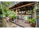 Rustic outdoor bar area with tropical decor, perfect for entertaining guests at 1151 Lancer Ln, Tarpon Springs, FL 34689