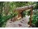 Outdoor pergola with a lattice accent, bench, and lush landscaping creating a tranquil and shaded retreat at 1151 Lancer Ln, Tarpon Springs, FL 34689